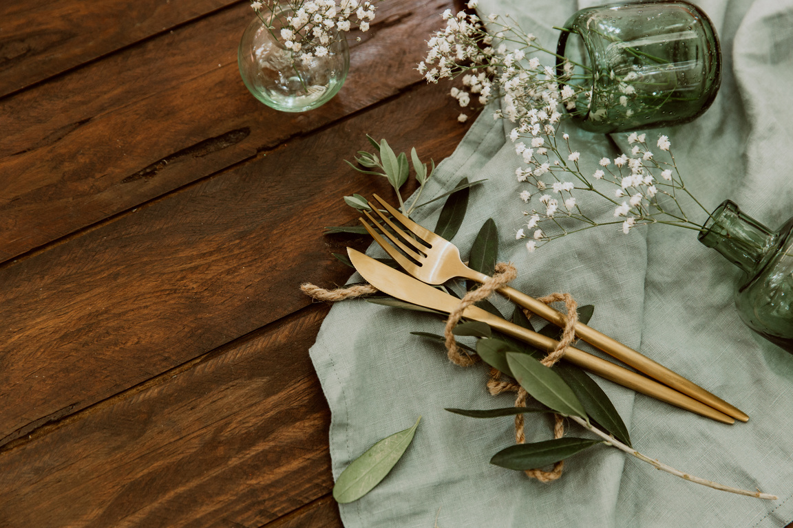 Rustic wedding table decorations on wooden table. Top view. Bohemian wedding tableware. Flat lay