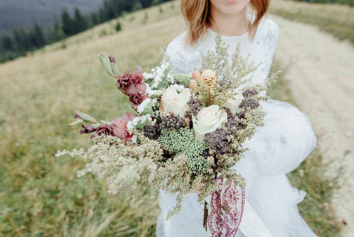 Photoshoot of the bride in the mountains. Boho style wedding photo.